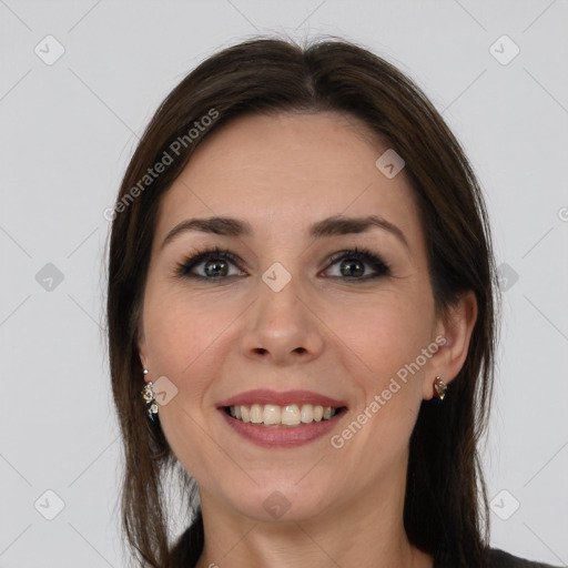 Joyful white young-adult female with long  brown hair and grey eyes