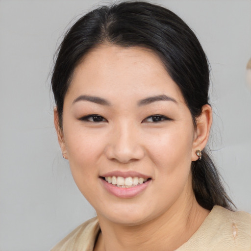 Joyful asian young-adult female with medium  black hair and brown eyes
