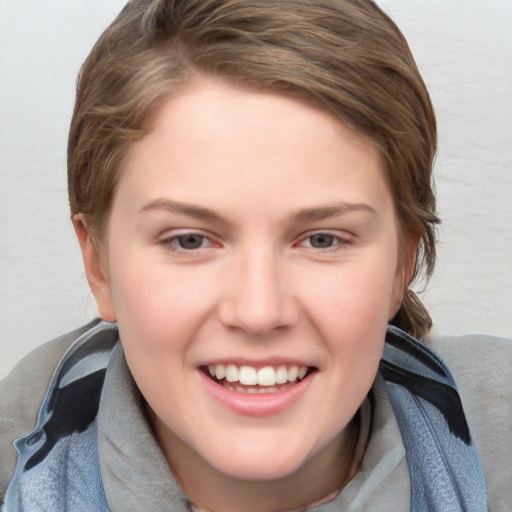 Joyful white young-adult female with medium  brown hair and blue eyes