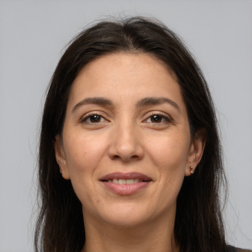 Joyful white adult female with long  brown hair and brown eyes