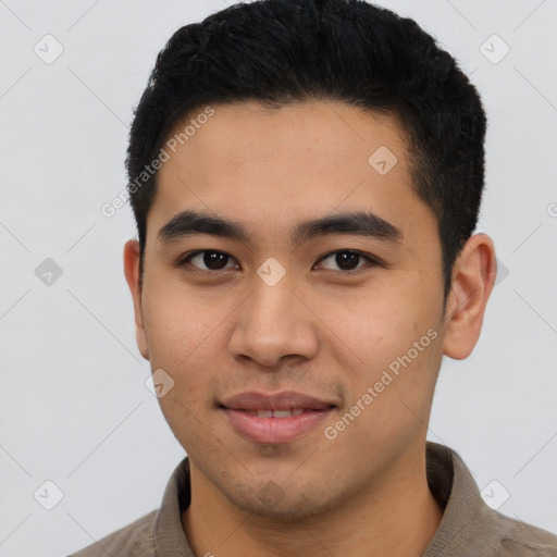 Joyful latino young-adult male with short  black hair and brown eyes