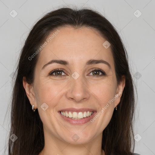 Joyful white adult female with long  brown hair and brown eyes