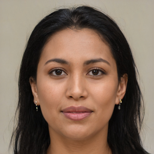 Joyful latino young-adult female with long  brown hair and brown eyes