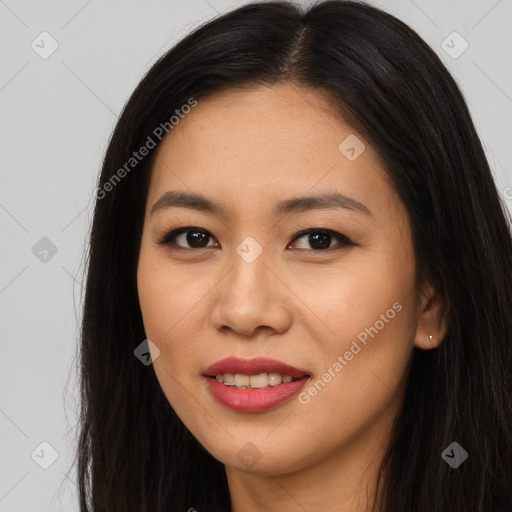 Joyful asian young-adult female with long  brown hair and brown eyes