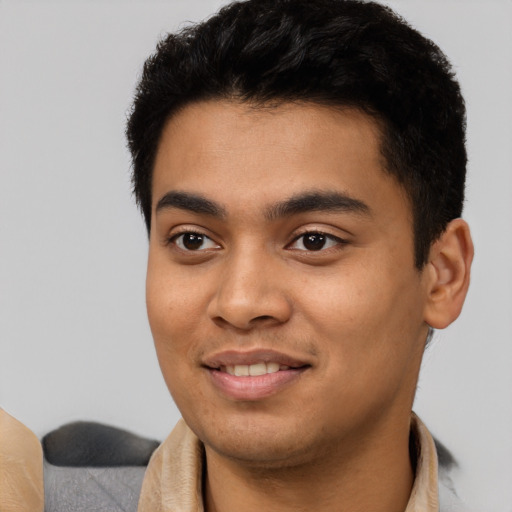 Joyful latino young-adult male with short  black hair and brown eyes