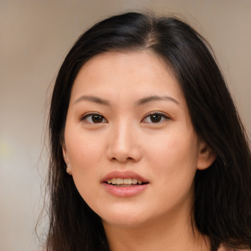 Joyful asian young-adult female with long  brown hair and brown eyes