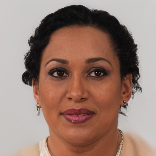 Joyful latino adult female with short  brown hair and brown eyes