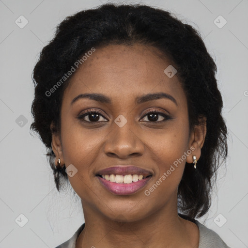 Joyful black young-adult female with long  black hair and brown eyes