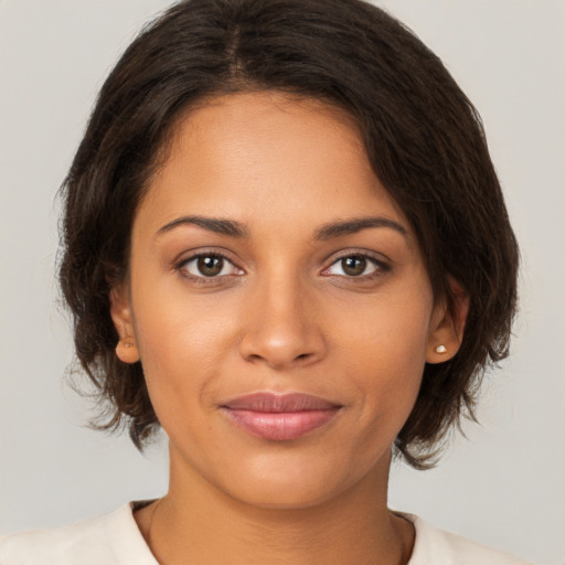 Joyful latino young-adult female with medium  brown hair and brown eyes