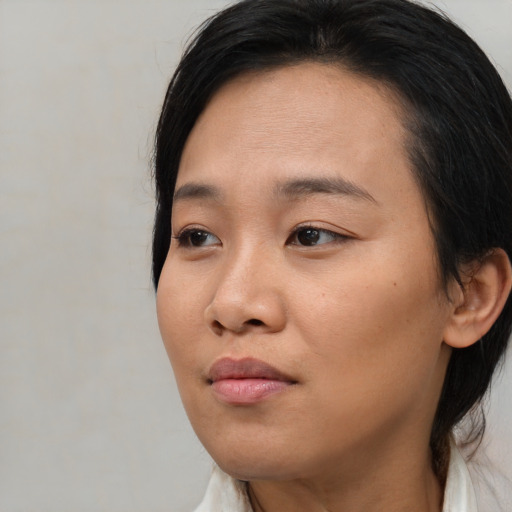 Neutral asian young-adult female with medium  brown hair and brown eyes