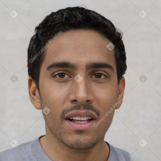 Joyful white young-adult male with short  black hair and brown eyes