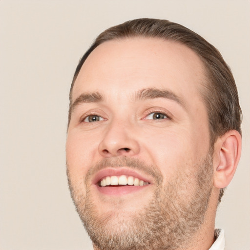 Joyful white adult male with short  brown hair and brown eyes