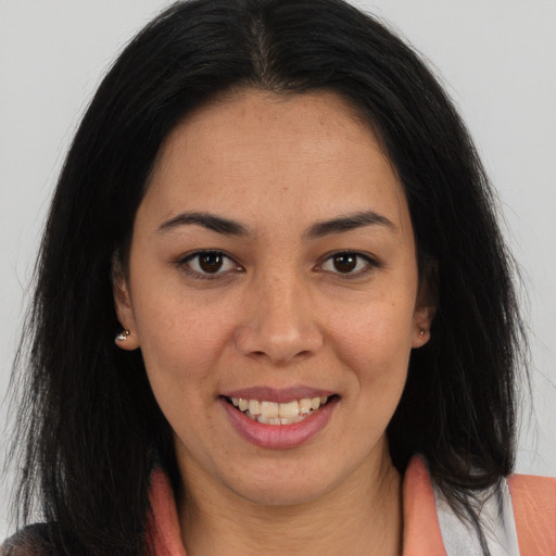 Joyful latino young-adult female with long  brown hair and brown eyes