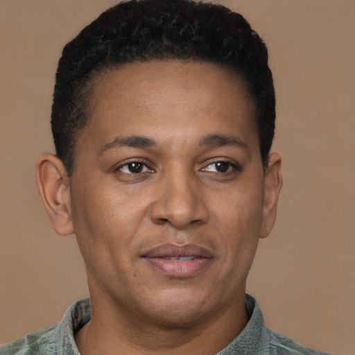 Joyful latino adult male with short  black hair and brown eyes