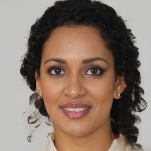 Joyful black young-adult female with medium  brown hair and brown eyes