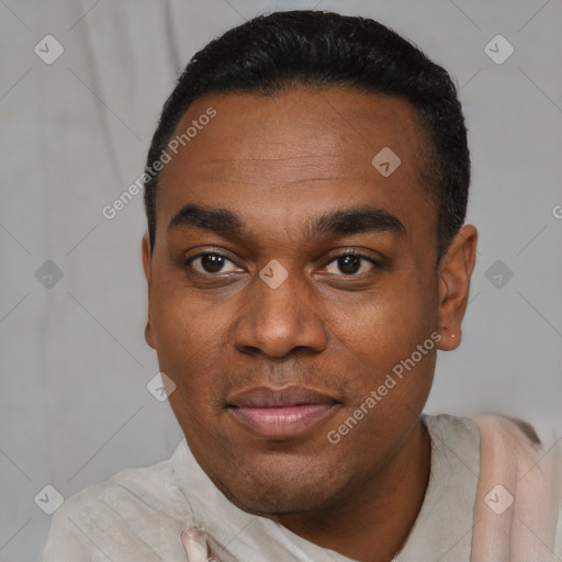 Joyful black young-adult male with short  black hair and brown eyes