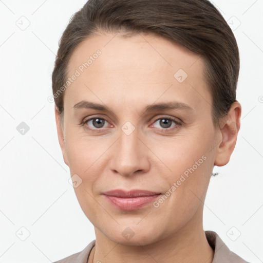 Joyful white young-adult female with short  brown hair and brown eyes