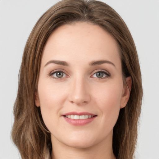 Joyful white young-adult female with long  brown hair and grey eyes