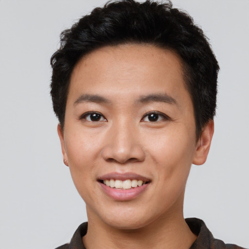 Joyful asian young-adult male with short  black hair and brown eyes