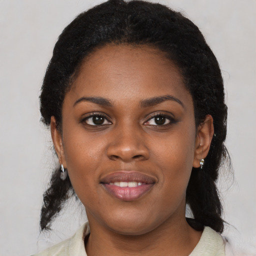Joyful black young-adult female with medium  black hair and brown eyes