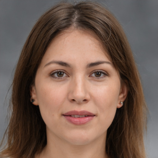 Joyful white young-adult female with long  brown hair and brown eyes