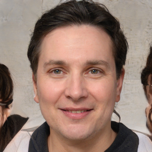 Joyful white adult male with medium  brown hair and brown eyes