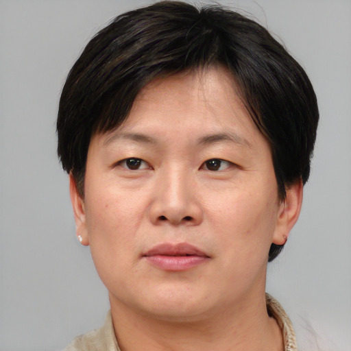 Joyful asian adult female with short  brown hair and brown eyes