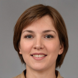 Joyful white young-adult female with medium  brown hair and brown eyes