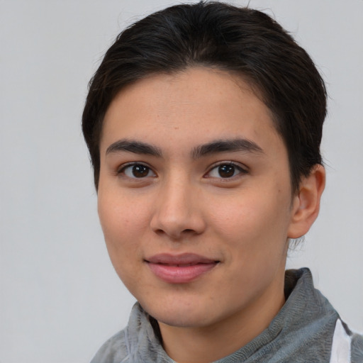 Joyful asian young-adult female with short  brown hair and brown eyes