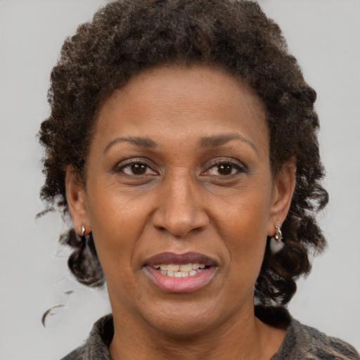 Joyful black adult female with short  brown hair and brown eyes