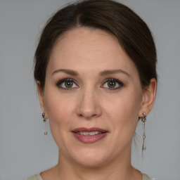 Joyful white adult female with medium  brown hair and grey eyes