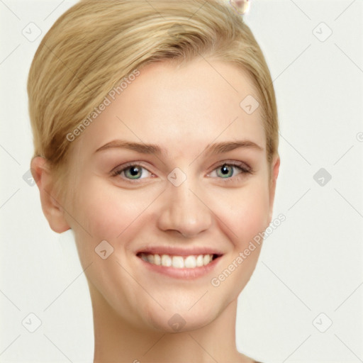 Joyful white young-adult female with short  brown hair and blue eyes