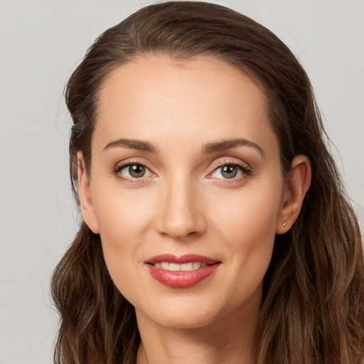 Joyful white young-adult female with long  brown hair and grey eyes