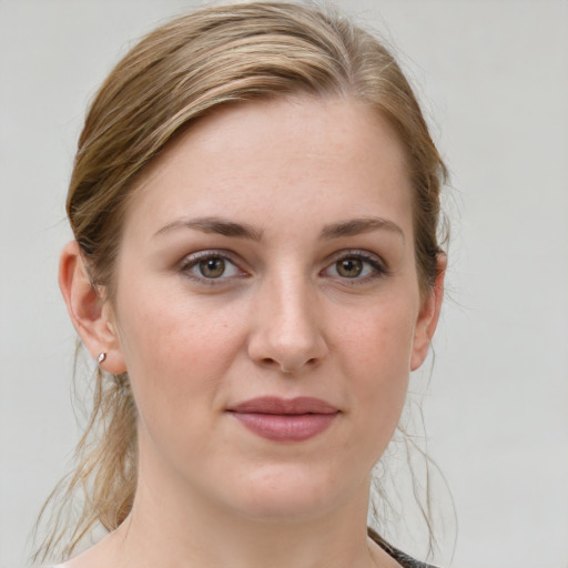 Joyful white young-adult female with medium  brown hair and grey eyes