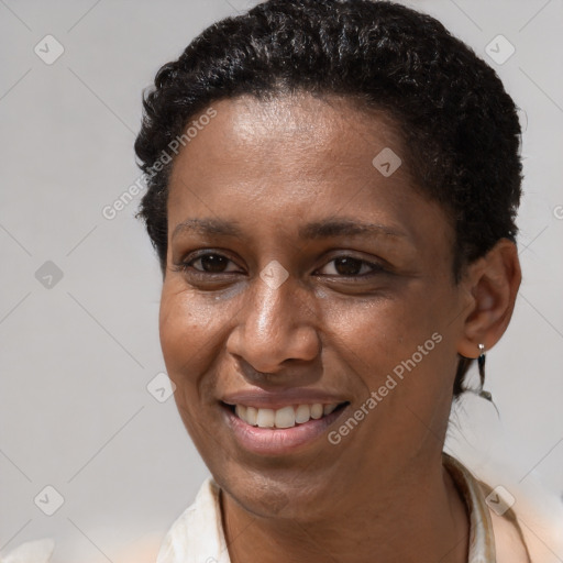 Joyful black adult female with short  brown hair and brown eyes