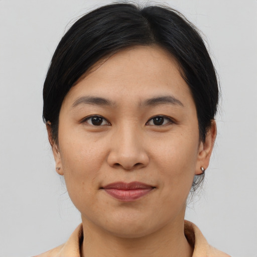 Joyful asian young-adult female with medium  brown hair and brown eyes