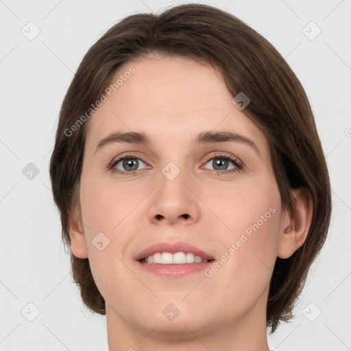 Joyful white young-adult female with medium  brown hair and green eyes