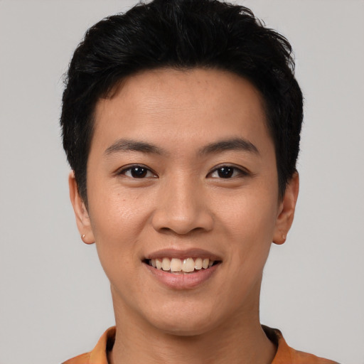 Joyful asian young-adult male with short  black hair and brown eyes