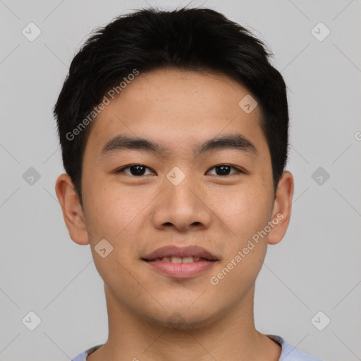 Joyful asian young-adult male with short  black hair and brown eyes