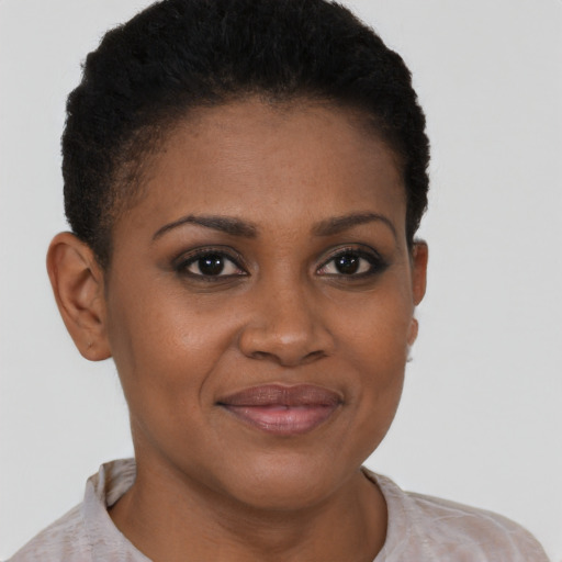 Joyful black young-adult female with short  brown hair and brown eyes
