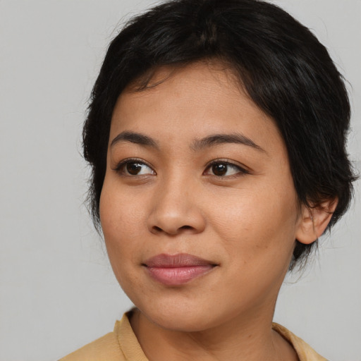 Joyful asian young-adult female with medium  brown hair and brown eyes