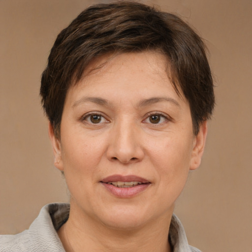 Joyful white adult female with short  brown hair and brown eyes