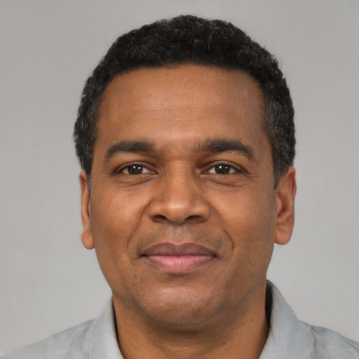 Joyful latino adult male with short  black hair and brown eyes