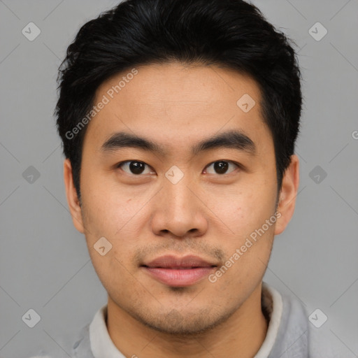 Joyful asian young-adult male with short  black hair and brown eyes