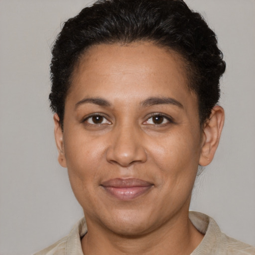 Joyful latino adult female with short  brown hair and brown eyes