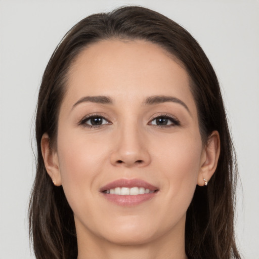 Joyful white young-adult female with long  brown hair and brown eyes