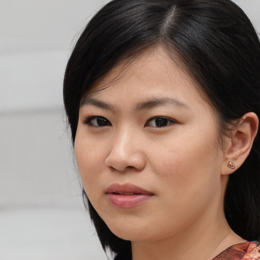 Joyful asian young-adult female with medium  black hair and brown eyes