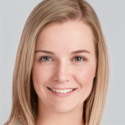 Joyful white young-adult female with long  brown hair and blue eyes