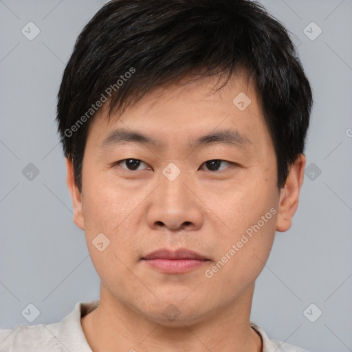 Joyful asian young-adult male with short  brown hair and brown eyes