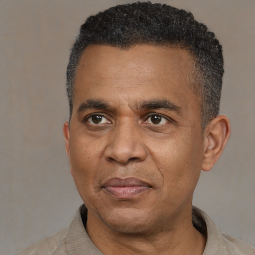 Joyful black adult male with short  black hair and brown eyes